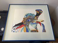Front view of framed colorful bird artwork by A Sherpen