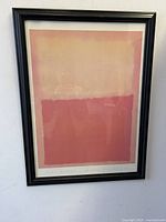 Front view of framed Mark Rothko style abstract art poster hung on wall showing orange and yellow color blocks.