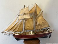 Side view of the full model ship displaying wooden hull, masts, sails rigging and propeller.