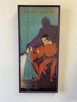Framed Theatre Aquarius jester theatrical poster featuring a red-orange costumed jester with a blue and purple background, marked 22" x 10".