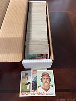 Box filled with a large stack of baseball cards with two cards representing Boston Red Sox players Bill Lee and Bob Stanley shown in front.