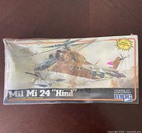 Sealed model kit box of 1984 MPC Mil Mi 24 Hind gunship helicopter in scale 1/72 with helicopter artwork on cover.