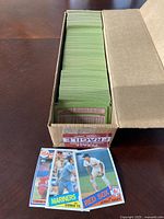 Box of 1985 Topps baseball cards showing green backs and multiple cards visible with player images and team logos.