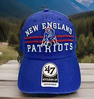 Front view of new blue trucker mesh adjustable hat with New England Patriots embroidery and original '47 Clean Up tags.