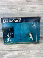 Box lid showing artwork of two baseball players in action and scoreboard graphics with game title.