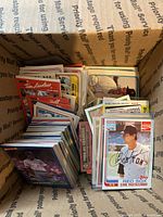 Small USPS Priority Mail box filled with a large collection of vintage baseball cards showing front cards such as Carl Yastrzemski Topps Red Sox card