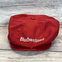 Top down view of the vintage Budweiser red beret hat showing embroidered logo and stitching.