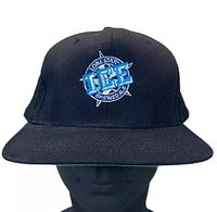 Front view of black snapback trucker hat showing embroidered Lone Star ICE Brewed Ale logo on front.