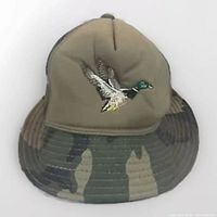 Front view of a camo bucket style hunting hat embroidered with a flying mallard duck, size medium.
