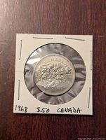 Obverse side of the 1968 Canadian 50 cent coin showing the Canadian Coat of Arms and inscriptions