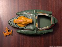 Top view of the green Wind-Raider vehicle with orange detachable ships placed beside it showing cockpit and decals.