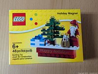 Front of the unopened LEGO Holiday Magnet box showcasing the assembled holiday scene and product details.