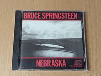 Front cover of Bruce Springsteen Nebraska CD showing artist name, album title, and grayscale road image.