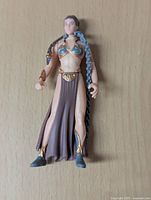 Front view of the Slave Leia figure showing the detailed outfit with gold and blue bikini top and brown skirt with slit.
