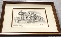 Framed black and white etching showing Falkland Palace building with signature by Brian Lewis, full artwork and frame visible.
