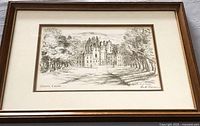 Framed etching of Glamis Castle in wood frame with white and brown matting, signed by Ann R. Thomas.