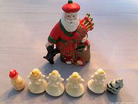 Vintage molded Christmas candles including four angels, one snowman and one snow-covered Christmas tree lined up