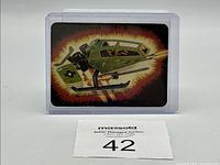 Front view of G.I. Joe action card #57 featuring Sky Hawk V.T.O.L. aircraft in protective sleeve with auction label.