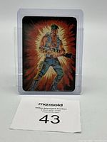 Front view of G.I. Joe trading card illustrating Gung Ho character with military gear and weapon, in plastic protective sleeve with lot number card in front.
