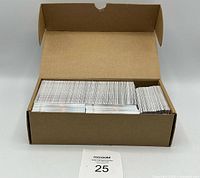 Open cardboard box filled with a large quantity of Upper Deck hockey cards mostly stacked upright inside.