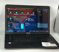 Front view of laptop powered on showing ASUS BIOS Utility EZ Mode screen