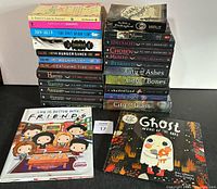 Full view of all books stacked including colorful and illustrated covers