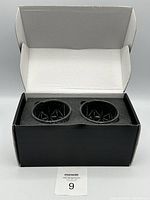 Top view of the black box with foam insert holding the two whiskey glasses securely inside.