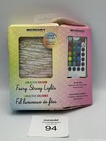 Front view of the Merkury multicolor fairy string lights box showing the iight string visible through a window and the remote control illustration.