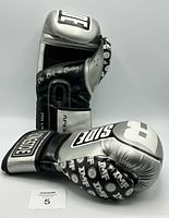 Front and side view of one boxing glove showing branding and finger design