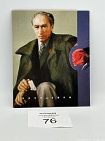Cover of presentation folder showing painted portrait of Pierre Trudeau holding a cigarette with years 1919-2000 and red rose accent.