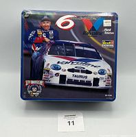 Front of the collector tin showing Mark Martin and the No. 6 Valvoline Ford Taurus racecar image with branding for NASCAR 50th Anniversary and Revell Monogram.