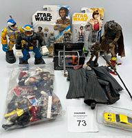 Close-up showing loose figures in plastic bag and Disney Darkwing Duck figures in front, Star Wars figures coming into frame behind