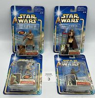 Four Hasbro Star Wars figures from 2001-2002 in original packaging, showing front view of blister cards and figure details