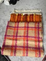 Three mohair blankets displayed on floor, showing colors and patterns of each blanket.