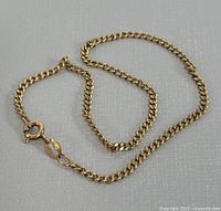 Full view of the 8.5-inch yellow gold chain bracelet laid out showing chain style and clasp.