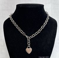 Front view of 17-inch silver heart pendant necklace on black display bust, showing chain and pendant