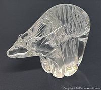 Front and side view of clear glass polar bear figurine showing detailed internal swirl patterns in the glass and overall shape.