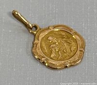 Front oblique view showing pendant relief design and bail