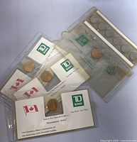 Vintage Canadian commemorative coins in TD Bank holders with Canadian flag and event labels