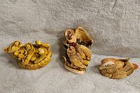 Three animal figurines: bear cub lying on back, owl with small owls, and duck with head tucked