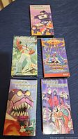 Photo showing five vintage Transformers VHS tapes with colorful 1980s cover artwork