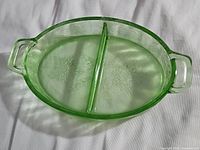 Top view of the green uranium glass divided platter showing etched floral pattern, central divider, and two handles