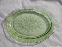 Full view of 12-inch oval Vaseline glass dish showing cameo ballerina pattern and integral handles.