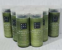 Front view of ten green bottles of Rituals Body Lotion, showing the label with product name and scent details.