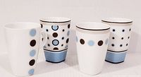 Four Maxwell & Williams squared base mugs with dot and stripe patterns on white porcelain with blue bases