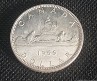 Reverse side of 1966 Canadian silver dollar featuring the canoe design and date 1966