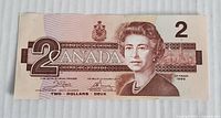 Front of the 1986 Bank of Canada $2 bill featuring Queen Elizabeth II and denomination markings.
