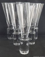 Full view of 6 clear Sasaki Colonnade champagne flutes, showing conical bowls and thick cylindrical bases