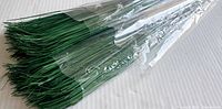 Photo of one package of green floral arranging greenery sticks wrapped in clear plastic.
