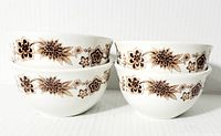 Four stacked bowls in two pairs showing floral pattern and dimensions.